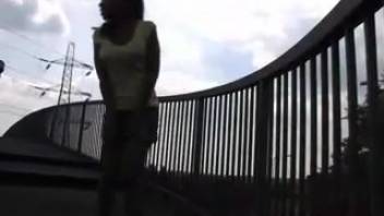 Ebony female urinating on the footbridge